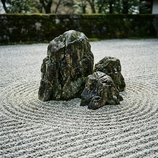 Creating flow with stones showing an island rock grouping and concentric raked patterns